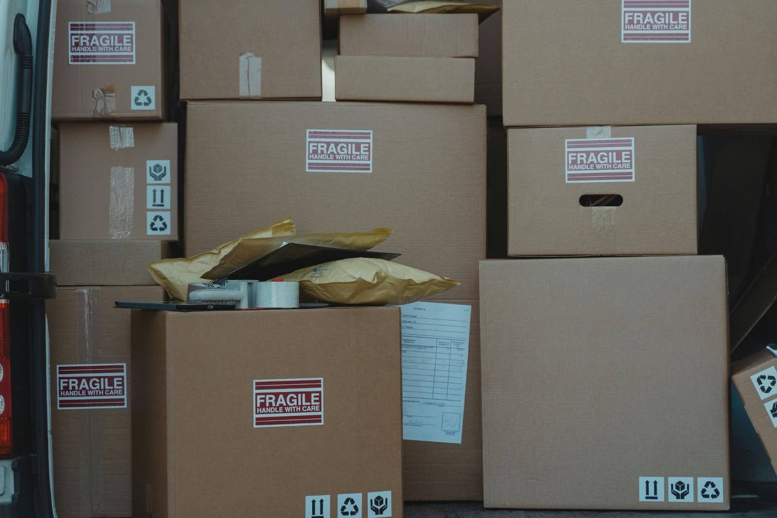Multiple consolidated boxes and padded parcels prepared for Amazon or B2B shipping in bulk.