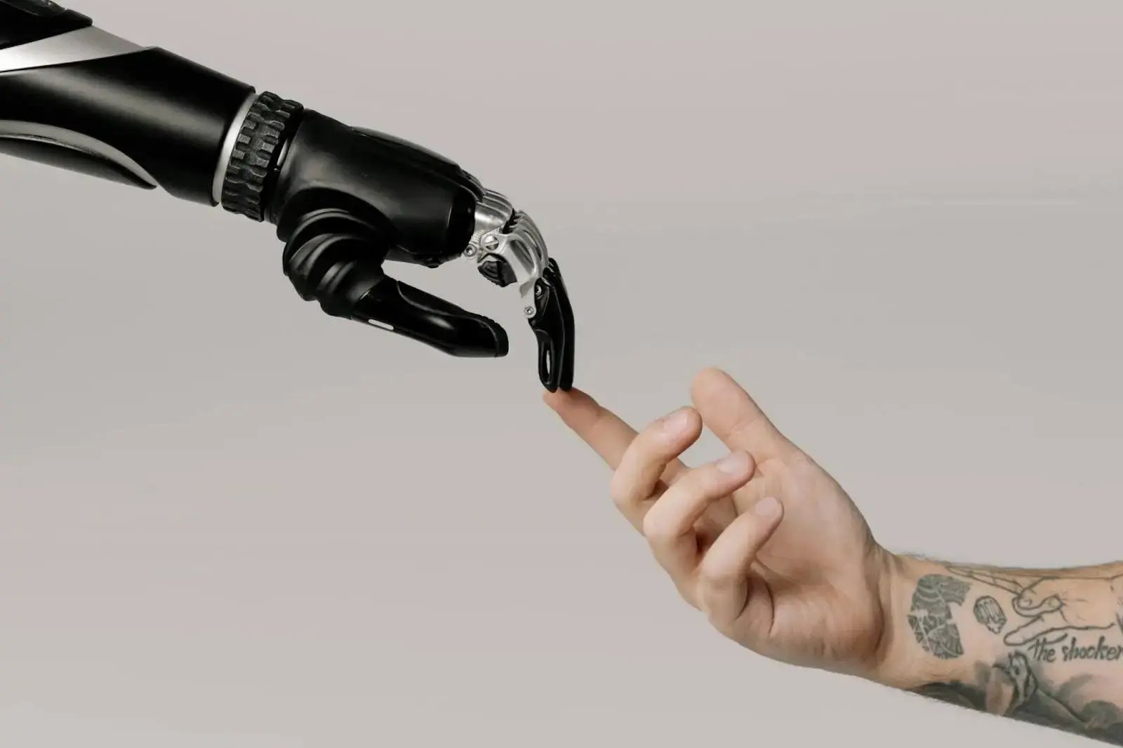 Symbolic image of a robotic hand connecting with a human hand, representing the future of EDI and automation in business communication.