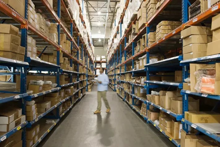 Warehouse manager conducting inventory check to support better stock control and turnover analysis.